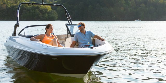 A couple in their Bayliner BR4 on the water in Muskoka near Toronto Ontario